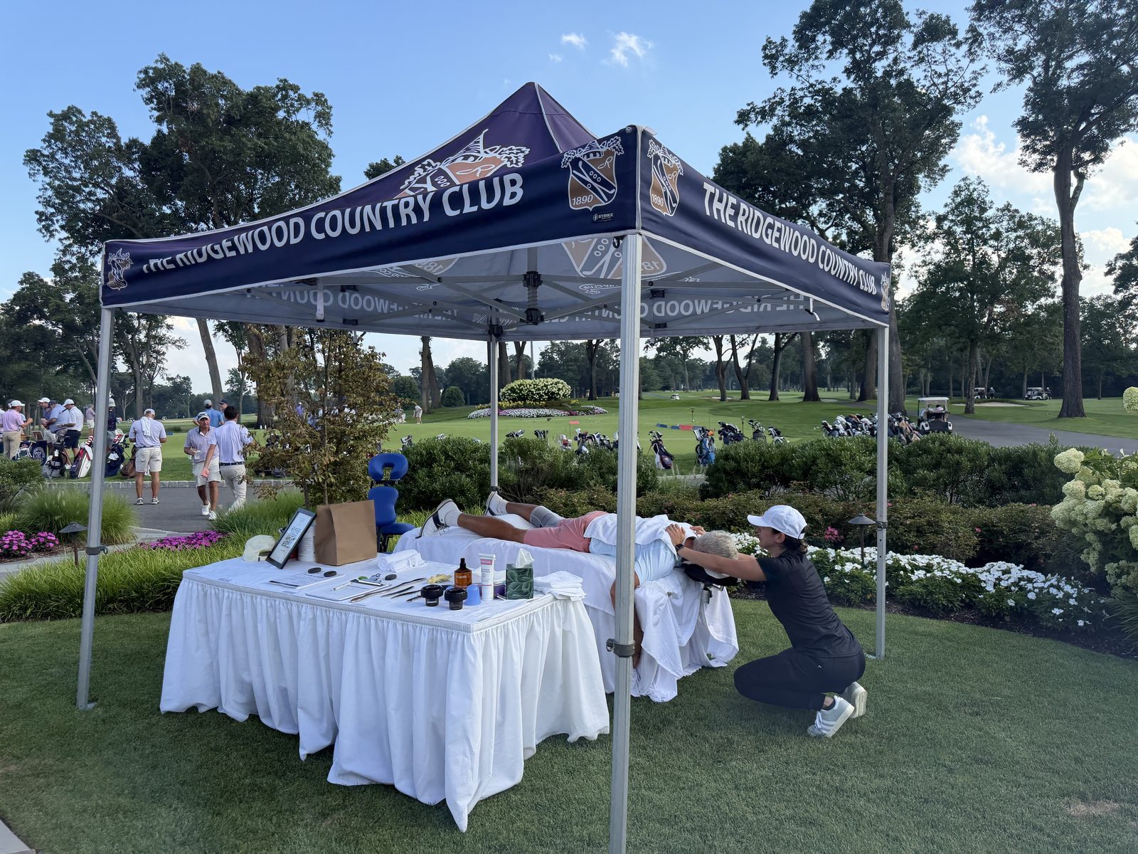 Rafya working on a golfer at the Kinetic table at the Ridgewood Country Club.